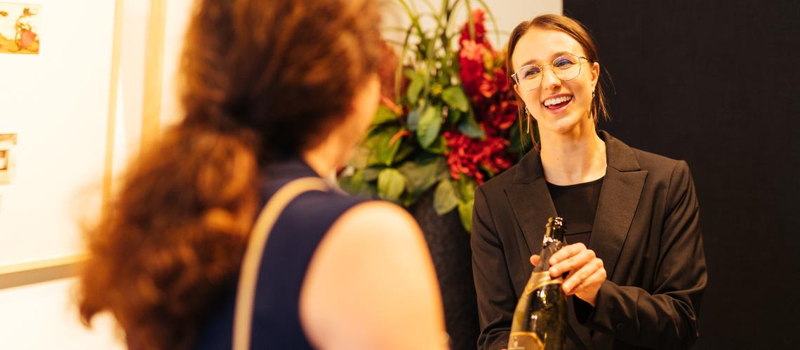 Friendly waiting staff presenting wine bottle at Cube 37 Frankston Arts Centre