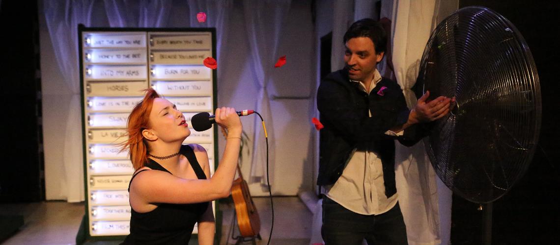 Love Song Dedications two performers rock out singing into a large fan Frankston Arts Centre