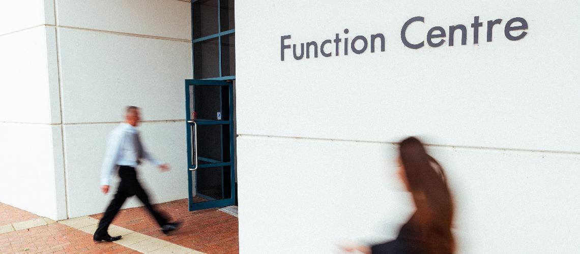 people hurriedly enter the function room entry at Frankston Arts Centre