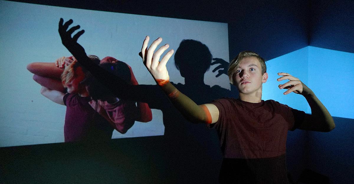 DangerClub boy with outstretched arms creating background shadows credit Jess Connell Frankston Arts Centre
